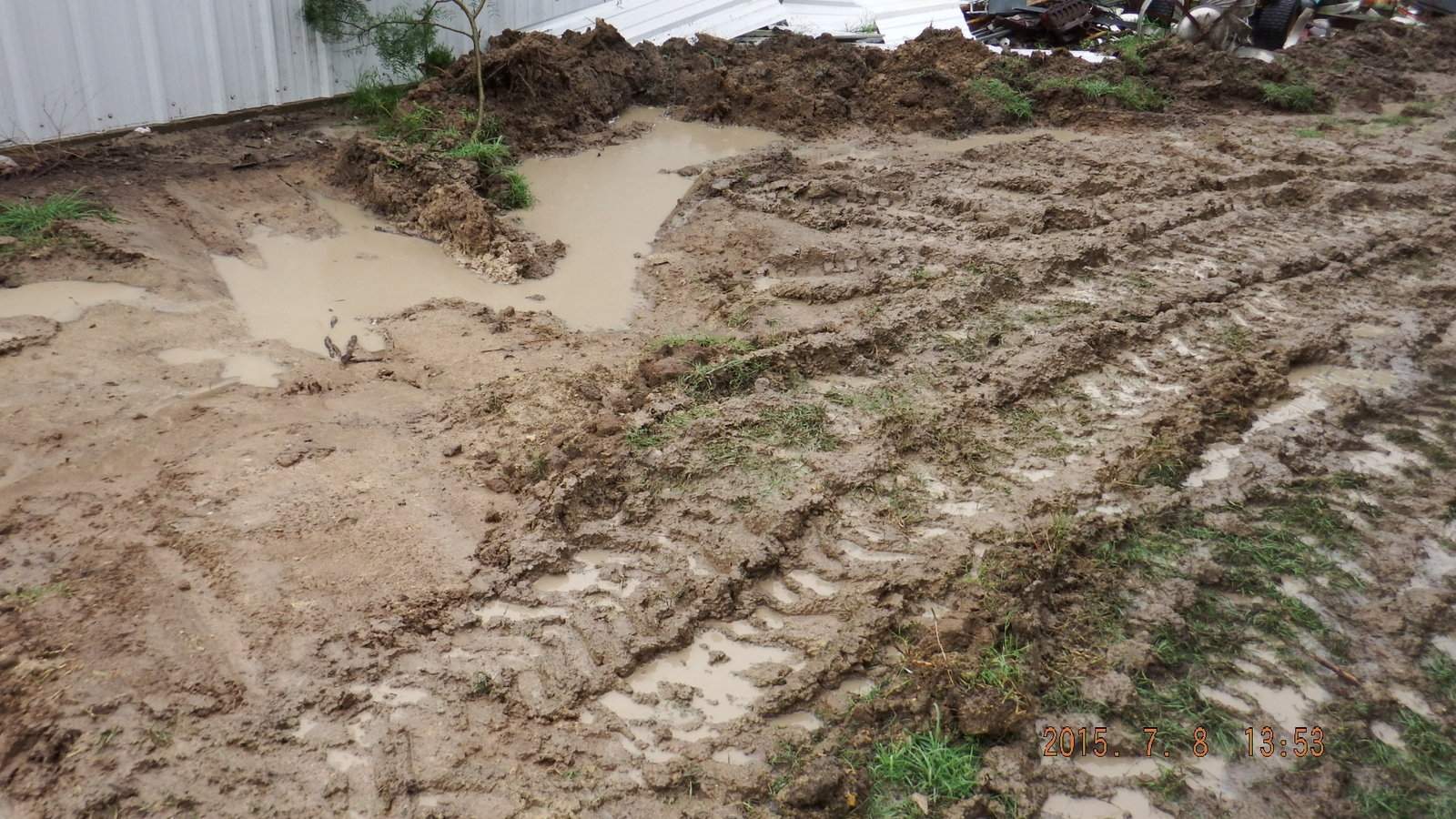 7_8_2015 5 Mud Hole made by the Kubota Tractor to Drain 7 inch rain fall.JPG