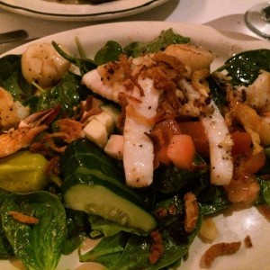 Seafood on spinach salad