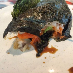 Half eaten spicy tuna handroll