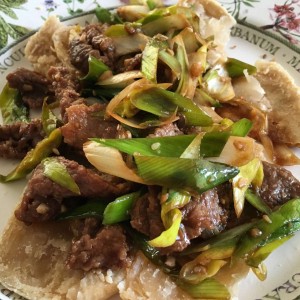 Veal with onions and leeks on sesame buns