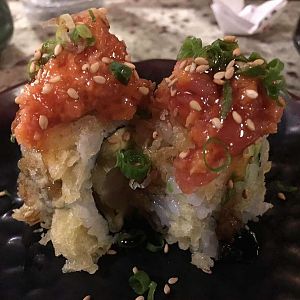 A roll with shrimp tempura and spicy ahi